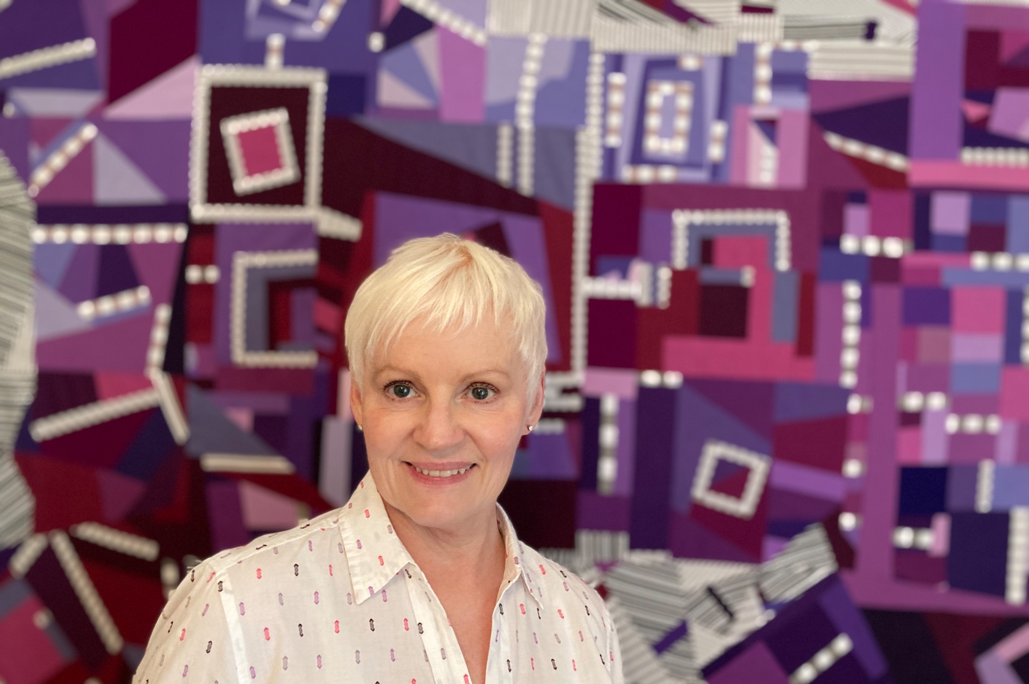 Jo Allbutt with one of her quilts